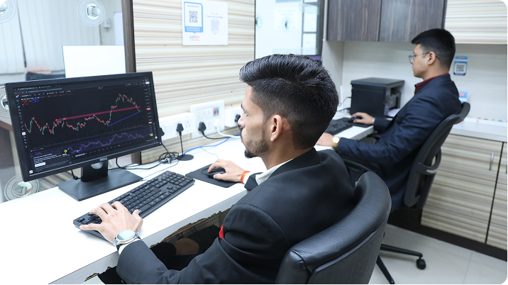 Trading experts collaborating and analyzing stock market graphs at Crystal Trading office